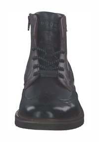 Schwarze Leder-Stiefeletten mit braunen Akzenten, ausgestattet mit einem vorderen Reißverschluss, kontrastierenden Schnürsenkeln und dekorativen Brogue-Details an der Spitze.