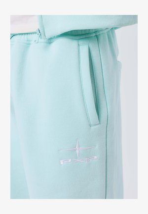 Light blue sweatpants with side pocket and white embroidered star logo with "PXP" on the thigh.