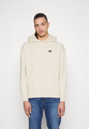 Sudadera beige de mezcla de algodón, con un bolsillo canguro frontal, capucha con cordón y un pequeño logo de la marca en el pecho.