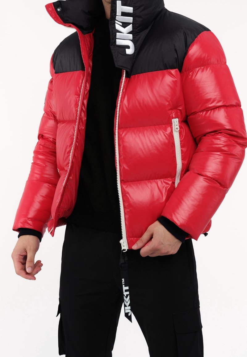 Red and black puffer jacket featuring a glossy finish, zip closure, ribbed cuffs, and a logo accent on the collar.