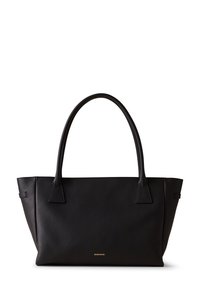 Black leather tote bag with a textured finish, featuring two long handles and a small gold logo at the bottom. Angular shape and minimal design.