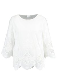 Blusa bianca con motivi floreali ricamati, orlo scallop e maniche a campana. Realizzata in tessuto leggero con una texture liscia.