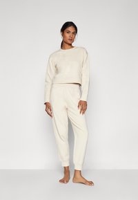Calvin Klein Underwear FRENCH TERRY LOGOPANTS - Spodnji del pižame - sandshell