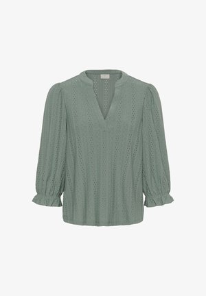 Jasnozielona bluzka z dekoltem w serek, bufiastymi długimi rękawami i falbankami przy mankietach. Tkanina ma teksturowany wzór ażurowy na całej powierzchni.