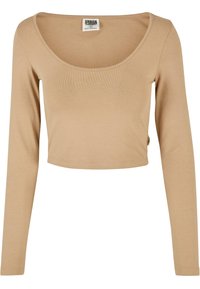 Langärmliges, cropped Oberteil in hellbeige, hergestellt aus weichem Baumwollgemisch. Verfügt über einen Rundhalsausschnitt und ein dezentes Etikett an der Seitennaht.