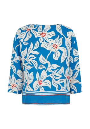 Blue long-sleeve blouse with white floral print and red flower centers, featuring a striped hem in white, red, and blue.
