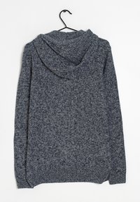 Bluza z kapturem w ciemnogranatowym, plecionym materiale o teksturowym wzorze. Charakteryzuje się luźnym krojem oraz ściągaczami na dole i przy rękawach.