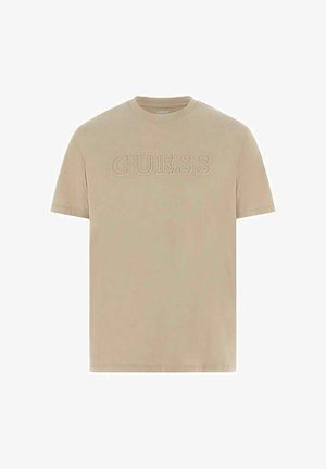 Beige T-shirt met korte mouwen en een ronde hals, met een reliëf "GUESS"-logo in het midden van de borst.