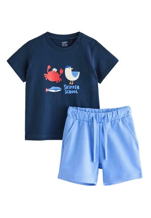 Mørkeblå t-shirt til småbørn med krabbe-, måge- og fiskegrafik samt teksten "Skipper School", kombineret med lyseblå shorts med elastisk talje.