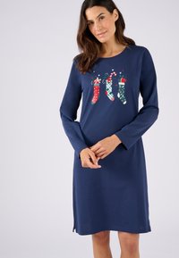Vestito lungo a maniche lunghe blu navy con un design stampato di calze di Natale colorate e bastoncini di zucchero. Tessuto morbido con spacchi laterali all'orlo.