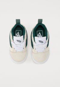 Sneakers z kremowym zamszowym czubkiem i zielonymi płótnami po bokach. Białe sznurówki i gumowa podeszwa. Logo na języku i widocznej etykiecie bocznej.