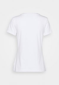 Vit bomulls t-shirt med korta ärmar, rund hals och en enkel design. Slät textur, inga mönster eller accenter synliga.