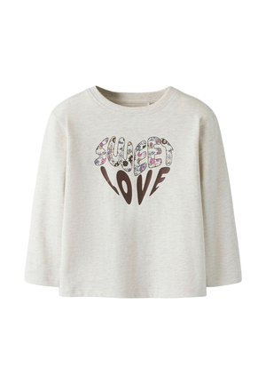 Light beige long-sleeve shirt made of soft fabric, featuring "SWEET LOVE" in colorful floral patterns with a brown heart shape below the text.
