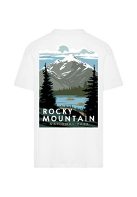 White T-shirt featuring a graphic of mountains, trees, and a lake, with "ROCKY MOUNTAIN NATIONAL PARK" in bold black and yellow lettering.