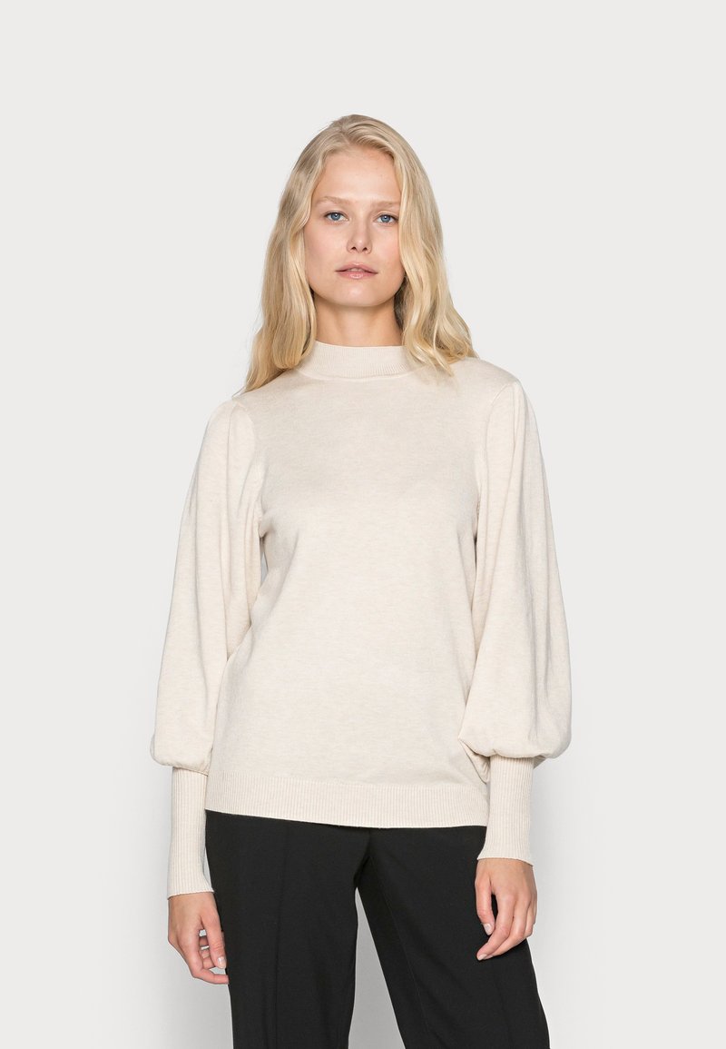 Beige Strickpullover mit hohem Kragen und puffärmel. Verfügt über gerippte Bündchen und Saum, aus einem weichen, leichten Stoff gefertigt.