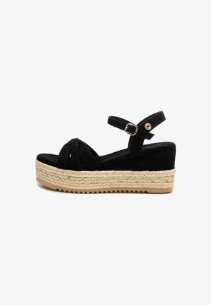 Sandali wedge neri in suede con dettagli intrecciati e cinturino alla caviglia, dotati di una piattaforma avvolta in juta e suola in gomma textured.