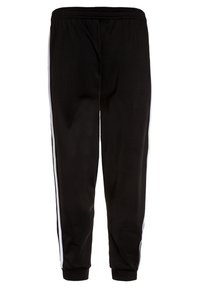 Svarta sportbyxor gjorda av slätt tyg, med vita sidostrikar, elastisk midja och åtsittande muddar vid anklarna.