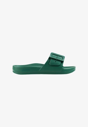 Green slip-on sandal with a wide adjustable strap and large rectangular buckle, flat sole, and molded footbed.