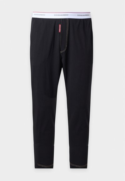 Pantalon long de sous-vêtement noir avec une taille élastique blanche marquée DSQUARED2 et des détails de couture contrastés.