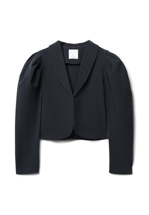 Veste noire raccourcie avec des manches bouffantes, tissu texturé et motif à pois subtil. Présente un col à revers et une fermeture à crochet à l'avant.