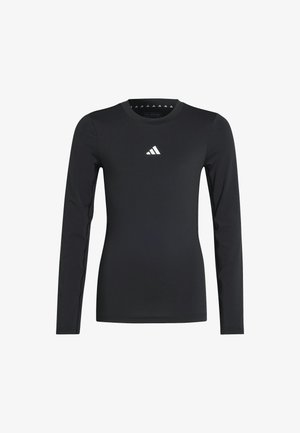 Maglietta sportiva nera a maniche lunghe realizzata in materiale liscio ed elastico. Presenta un piccolo logo bianco sul petto. Design semplice con scollatura rotonda.