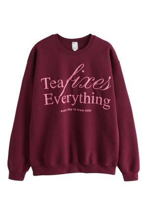 Bordeauxrode trui met roze tekst met de tekst "Thee lost alles op" en "elke dag is brew-tiful" in een casual lettertype.