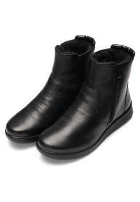 Bottines en cuir noir avec fermeture éclair latérale et doublure en polaire douce, bout arrondi et semelle plate conçues pour les temps froids.
