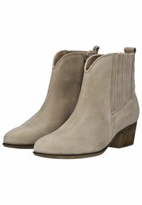 Botas de tobillo de ante beige con puntera puntiaguda, costuras laterales, paneles elásticos y un tacón bajo de madera apilada. Textura suave.