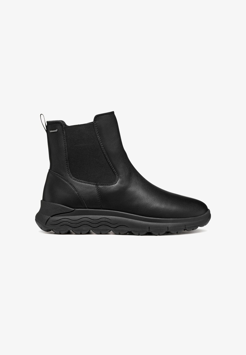 Botas de cuero negro hasta el tobillo con paneles elásticos laterales, puntera redondeada y suela de goma texturizada con un patrón en forma de ola. Con lengüeta en la parte posterior.