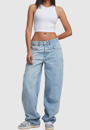 Vaaleansiniset farkut, joissa on rento istuvuus, viisi taskua ja hieman haalistunut pinta. Yhdistetty harmaiden tennareiden ja valkoisen lyhytpaitaiseen toppiin.