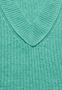 Maglione lavorato a maglia verde menta con scollo a V e costine testurizzate, che mette in risalto un tessuto morbido e caldo, ideale per sovrapposizioni.