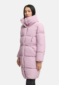 Light pink puffer coat with a high collar, featuring a quilted design, snap buttons, and a logo patch on the sleeve. Smooth texture.