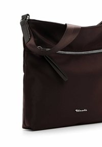 Brown nylon shoulder bag features a smooth texture, a zippered pocket, and a detachable strap. Silver hardware accents the brand logo.