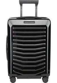 Valigia rigida nera con design a righe, dettagli in argento, maniglia telescopica e quattro ruote girevoli per una facile manovrabilità.