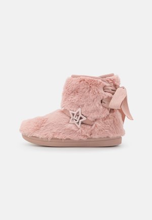 Pink fuzzy children's boot with star-shaped buckle and ribbon tie at the back, flat sole, side view on white background.