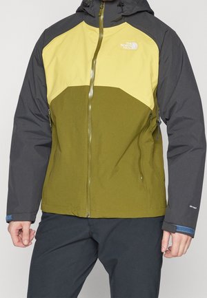 Veste d'extérieur pour homme à blocs de couleurs en vert olive, jaune et gris foncé, avec poches zippées et capuche.