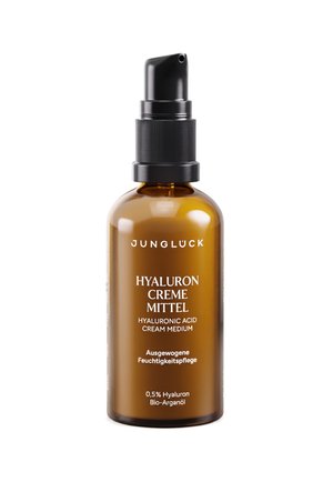 Brown glass bottle with black pump labeled Jungluck Hyaluronic Acid Cream Medium with 0.5% hyaluronic and bio-argan oil.
