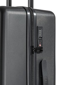Black hard-shell suitcase with a digital combination lock and zipper detailing near the top corner.