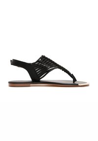 Black sandal featuring braided leather straps, open toe design, flat sole, and metallic accent at the front for added detail.