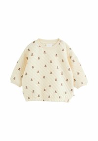 Quiltet cremelangt sweatshirt med brune bjørnemønstre, ribbet krave og elastisk kant. Har brede ærmer og knapdetalje på skulderen.