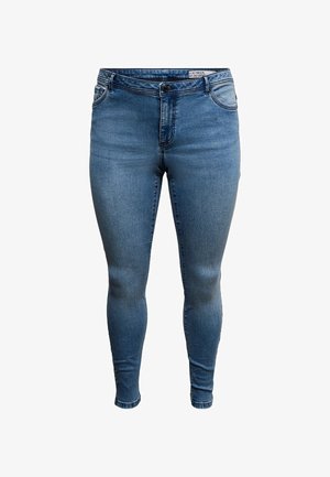 Jeans skinny feitos de ganga azul, com cintura de altura média, design clássico de cinco bolsos e desbotamento subtil nas coxas.