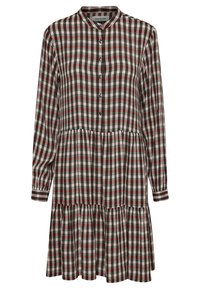 Robe à carreaux rouge, noir et blanc avec un devant boutonné, un col, des manches longues et un ourlet de jupe froncé. Fabriquée dans un tissu texturé.