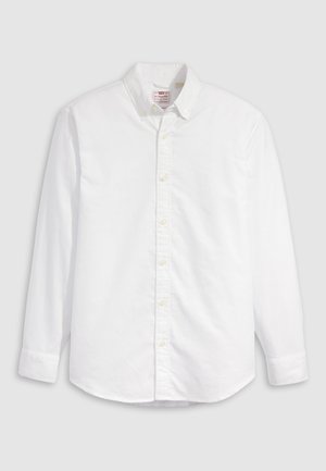 Cămașă albă cu nasturi, din bumbac, cu mâneci lungi, guler și tiv curbat. Prezintă nasturi galbeni și un branding subtil.