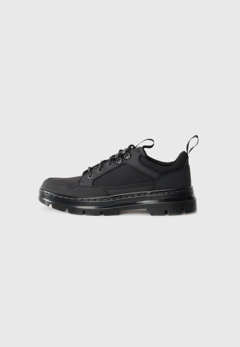 Black low-top sneaker with textured fabric and leather upper, thick ridged sole, metal eyelets, and pull tabs on tongue and heel.