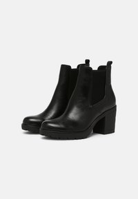 Black leather ankle boots with elastic side panels, rounded toe, and block heel. Features textured surface and pull tabs for easy wear.