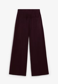 Wide-leg trousers in deep burgundy, featuring a smooth texture, two back pockets, and a flat waistband.