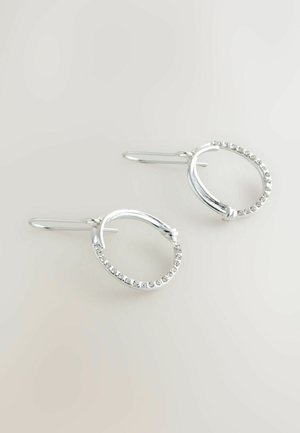 Silver hoop earrings with a textured design and a row of small rhinestones along the outer edge. Features a hook closure.