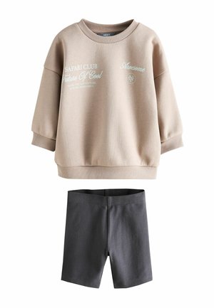 Beige long-sleeve sweatshirt with printed text and dark gray knee-length shorts set for children.