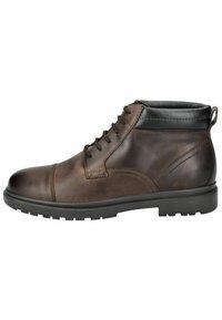 Botas de tobillo de cuero marrón con un acabado suave, puntera redonda, sistema de cordones y un acento de cuero negro alrededor del tobillo. Suela de goma.