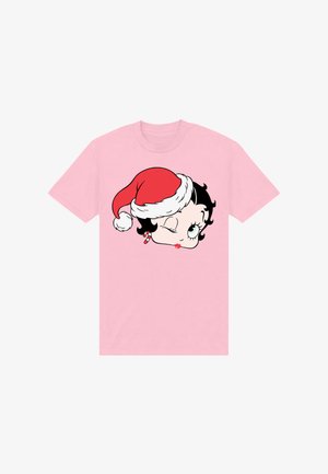 Lichtroze T-shirt met een knipogend cartoonvrouwtjesgezicht dat een rood-witte kerstmanmuts en rode lippenstift draagt, gecentreerd op de borst.